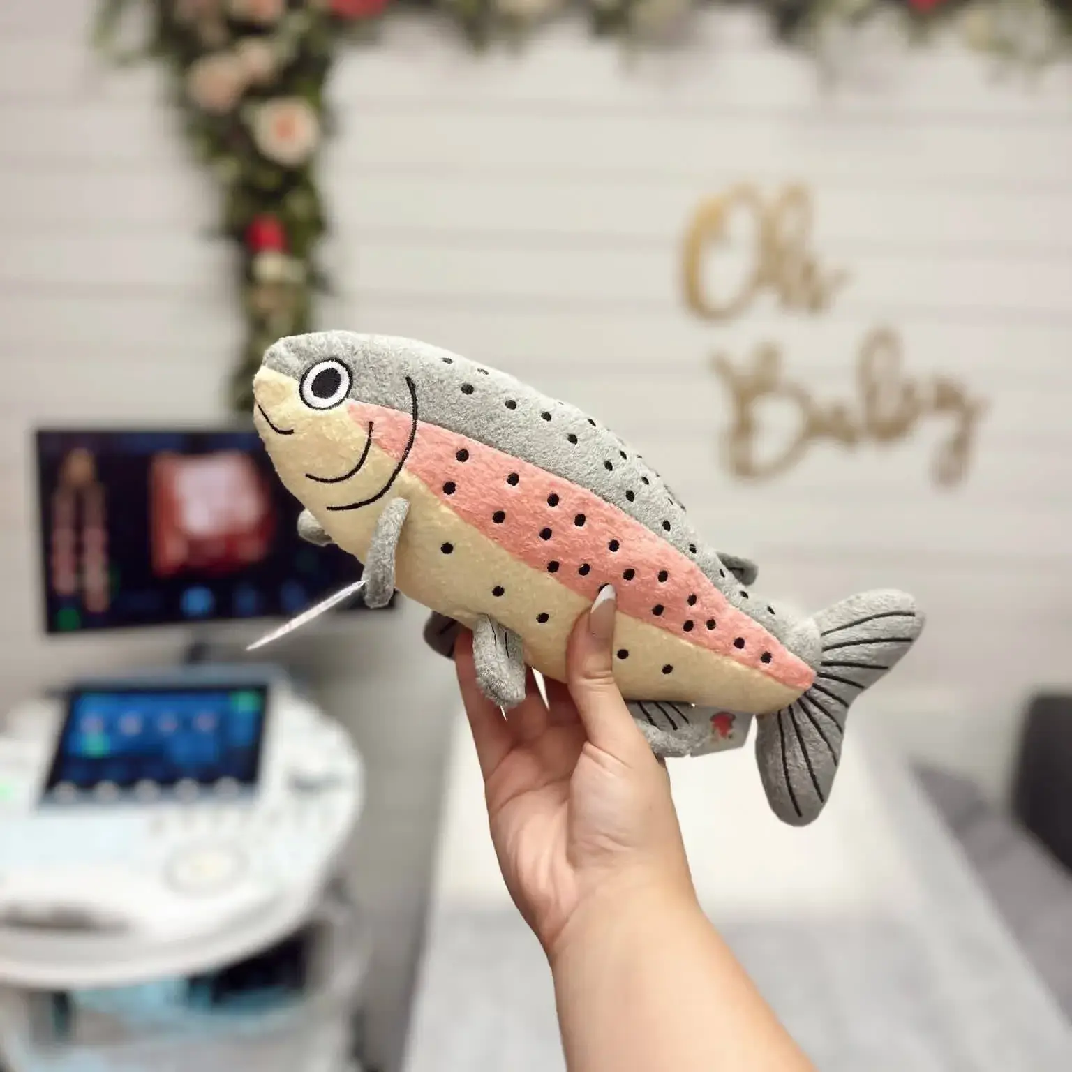 3D ultrasound image with plush fish toy and "Oh Baby" decoration